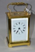 AN EARLY 20TH CENTURY FRENCH BRASS CARRIAGE CLOCK, the rectangular case with small oval panel to the