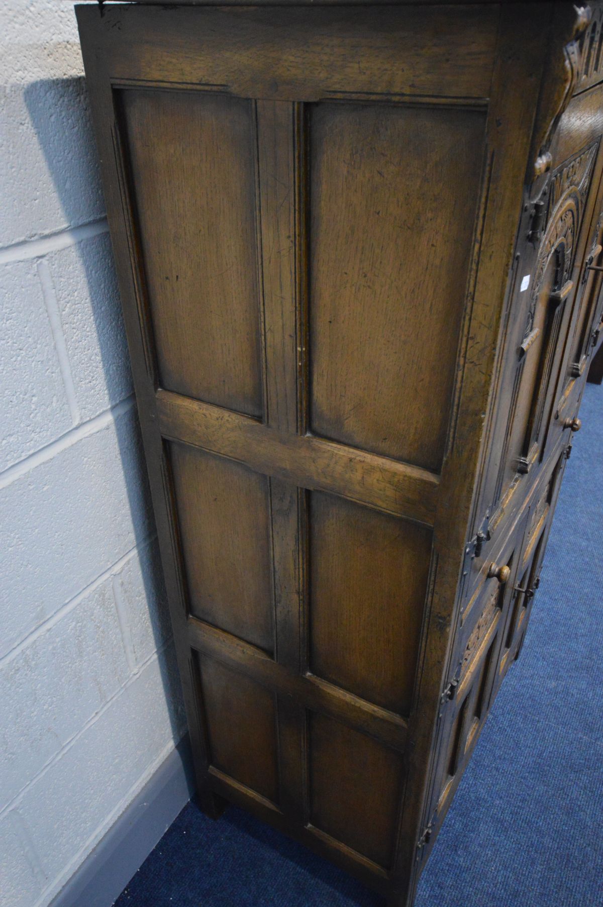 A REPRODUCTION OAK FOUR DOOR DRINKS CABINET, the arched panel door enclosing an arched shelf, and - Image 7 of 8