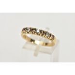 A YELLOW METAL DIAMOND HALF ETERNITY RING, designed with a row of claw set brown and white, round