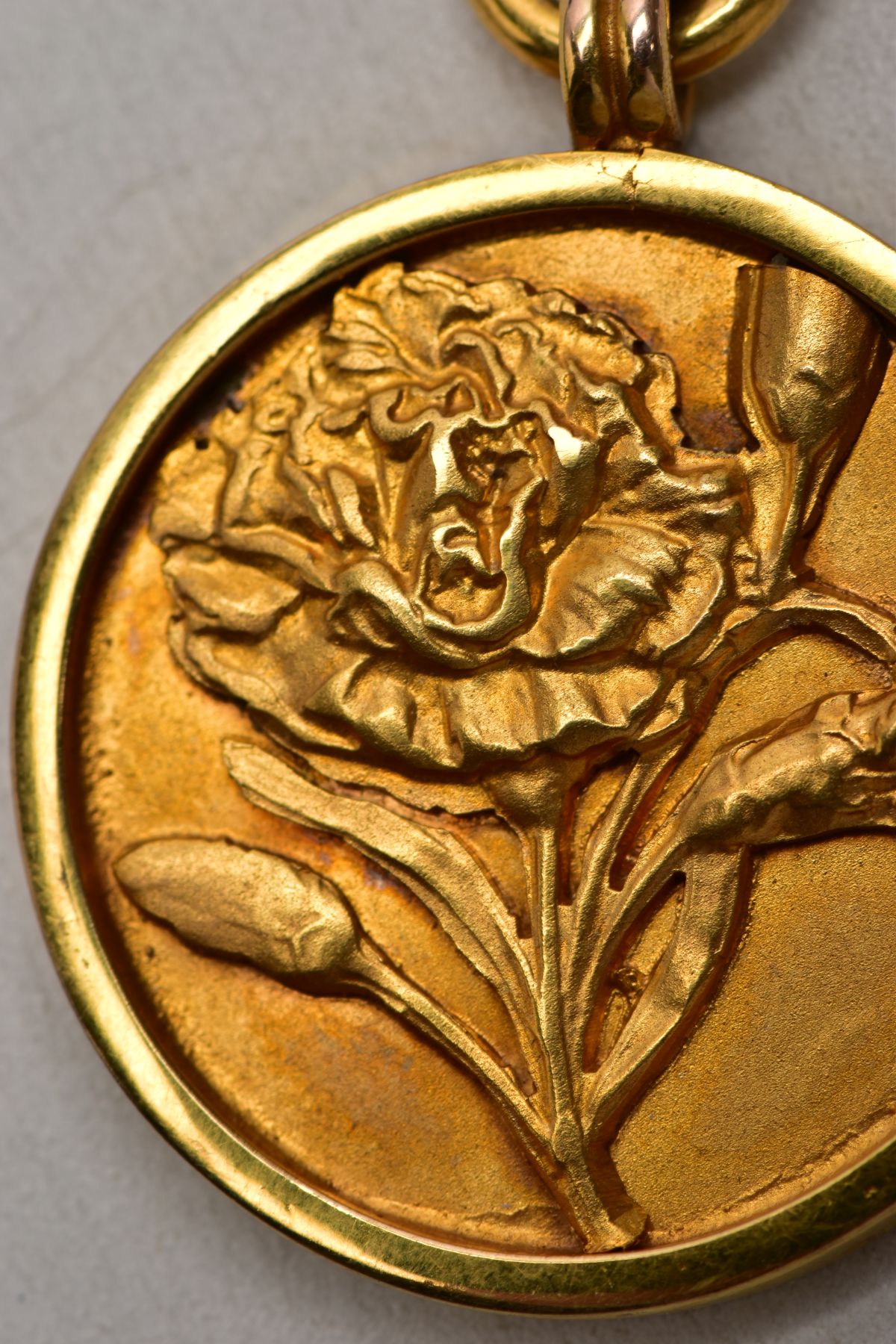 A 9CT GOLD FOB MEDAL, of a circular form, decorated with an embossed flower to the front, engraved - Image 2 of 5