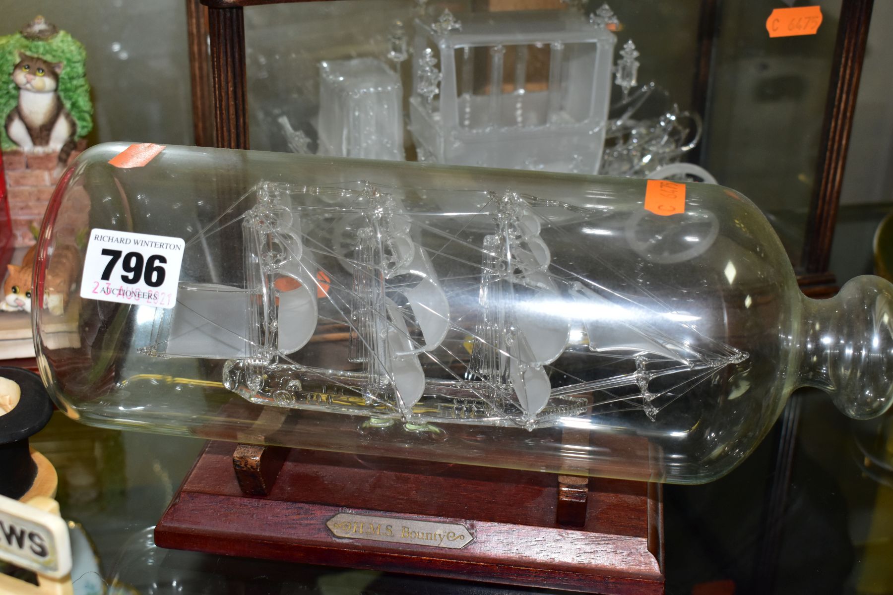 'THE GLASS COACH' IN DISPLAY CASE AND GLASS MODEL OF H.M.S. BOUNTY IN A BOTTLE, comprising a limited