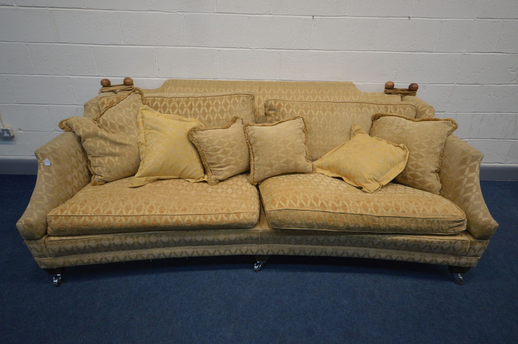 A WALNUT AND GOLD UPHOLSTERED DURESTA HORNBLOWER KNOWLE SOFA, with drop ends to each end, on