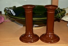 A PAIR OF DOULTON BROWN GLAZED CANDLESTICKS AND A STUDIO POTTERY TWIN HANDLED BOWL, the candlesticks
