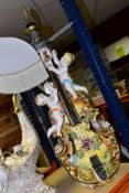 A LARGE CONTINENTAL PORCELAIN LAMP BASE, in the form of a violin with putti and encrusted with roses