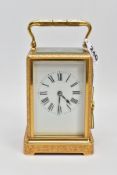 A BRASS CARRIAGE CLOCK, white dial, Roman numerals, five glass panels, engraved floral and foliate