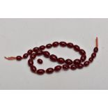 A STRING OF BAKELITE BEADS, comprising of thirty one beads and a further loose bead, measuring 3.5mm
