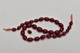 A STRING OF BAKELITE BEADS, comprising of thirty one beads and a further loose bead, measuring 3.5mm