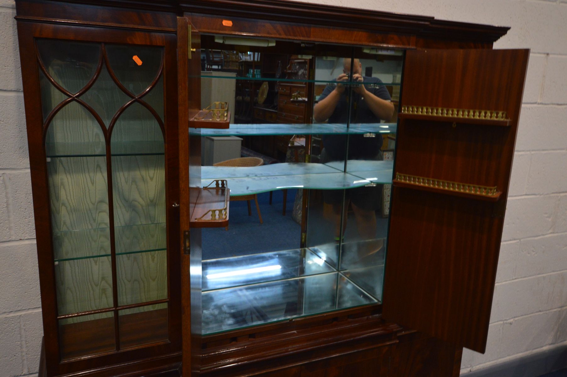 A REPRODUDUCTION MAHOGANY BREAKFRONT BOOKCASE/COCKTAIL CABINET, the top section with two glazed - Image 2 of 4