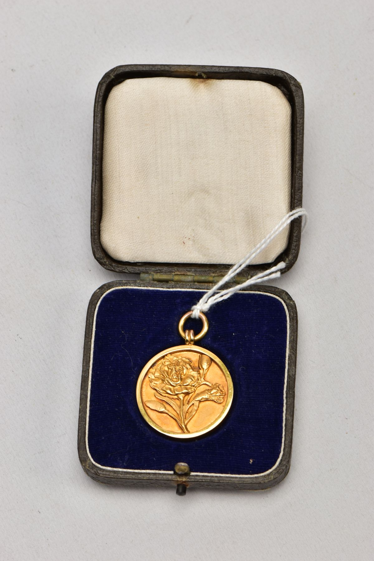 A 9CT GOLD FOB MEDAL, of a circular form, decorated with an embossed flower to the front, engraved - Image 5 of 5