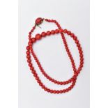 A DYED CORAL BEAD NECKLACE, designed as a row of graduated dyed coral beads measuring