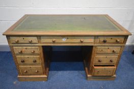 AN EDWARDIAN WALNUT PEDESTAL DESK, with a green leather and gilt tooled inlay top, and nine assorted