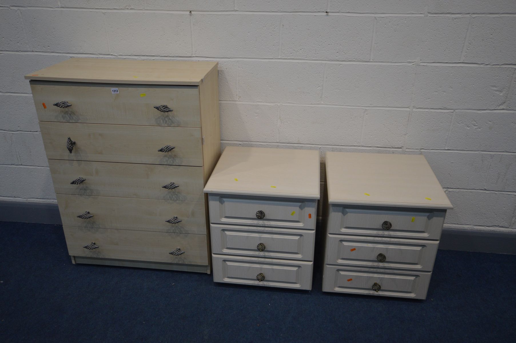 A TALL MODERN BEECH CHEST OF FIVE LONG DRAWERS, and a pair of three drawer bedside cabinets (one