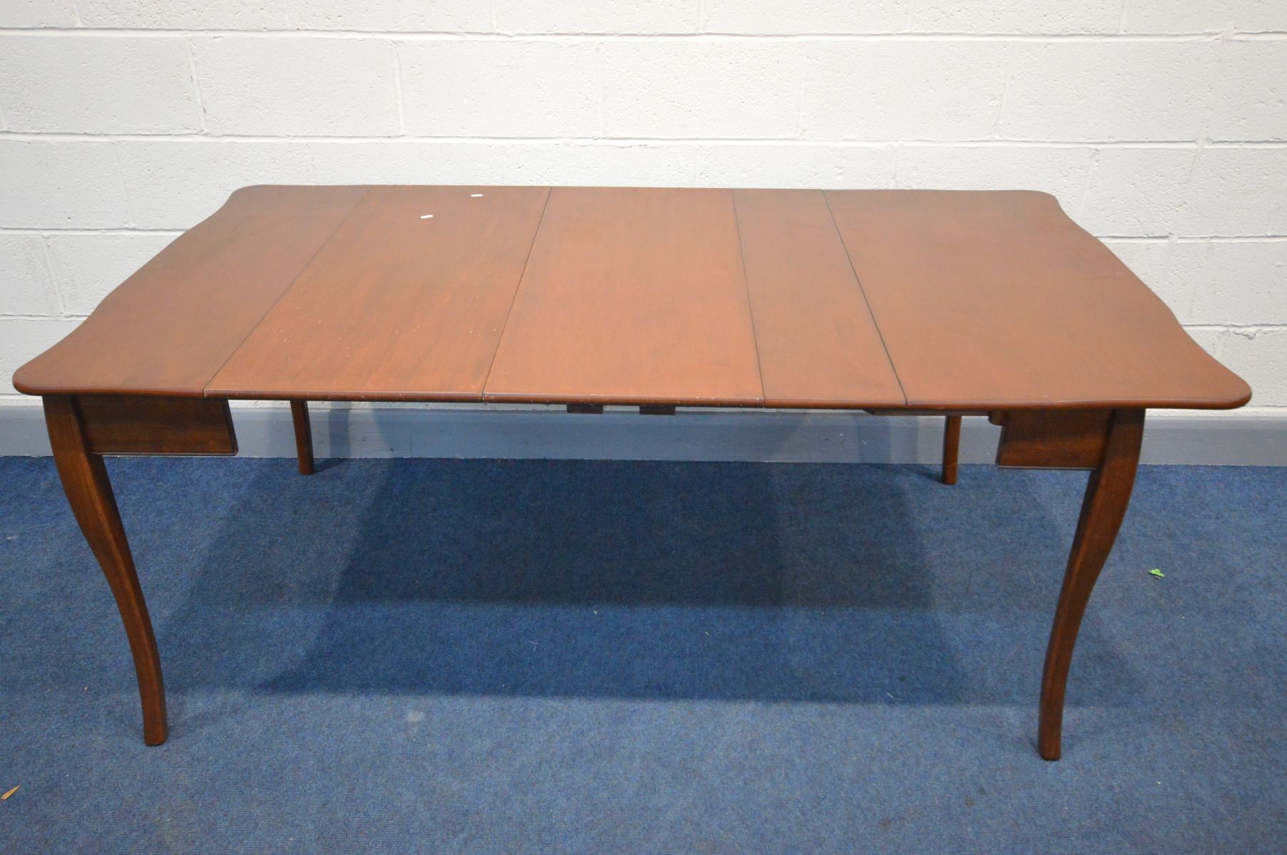 AN CHERRYWOOD EXTENDING DINING TABLE, that folds out from a tea table, with two additional leaves,