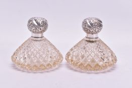 A PAIR OF EARLY 20TH CENTURY CLEAR CUT GLASS SCENT BOTTLES OF COMPRESSED CONICAL FORM, both with