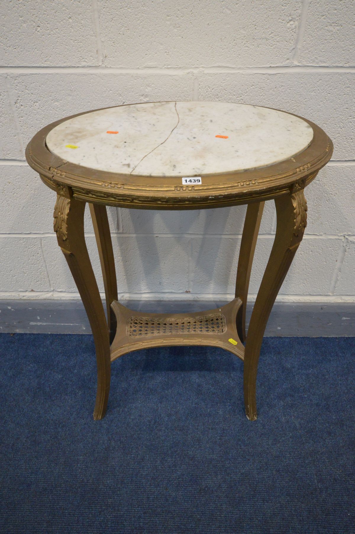 A 20TH CENTURY OVAL GILTWOOD OCCASSIONAL TABLE with a marble insert, on four splayed supports united