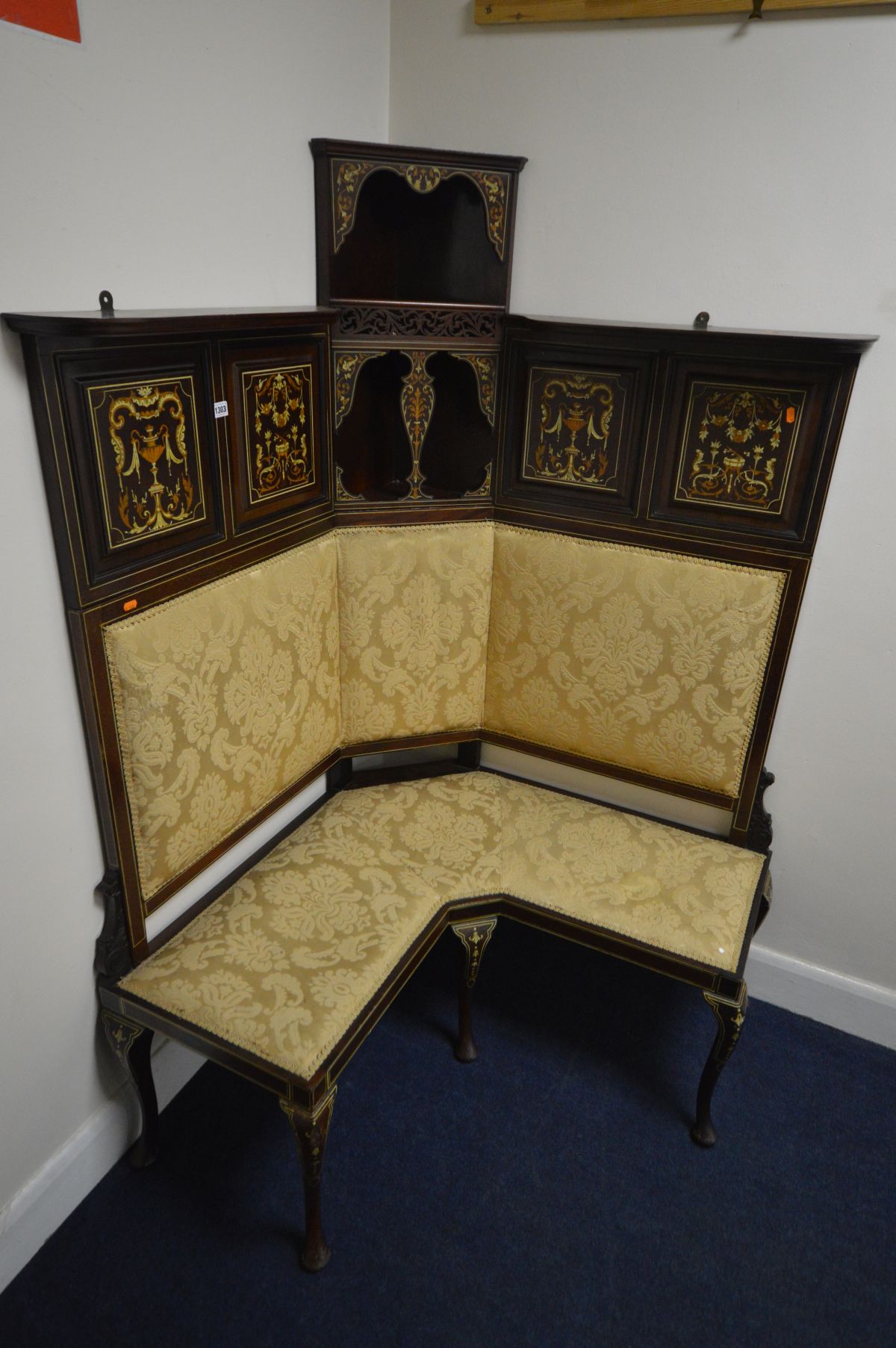 AN EDWARDIAN MAHOGANY AND MARQUETRY INLAID CORNER SOFA, the top section with four panels flanking