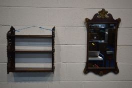 A GEORGIAN STYLE GILT AND MAHOGANY WALL MIRROR, 45cm x 82cm and a mahogany three tier wall shelf (