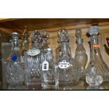 TEN CUT AND PRESSED GLASS DECANTERS AND BOTTLES, five with named porcelain decanter labels, one