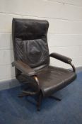 A BROWN LEATHER SWIVEL RECLINING ARMCHAIR