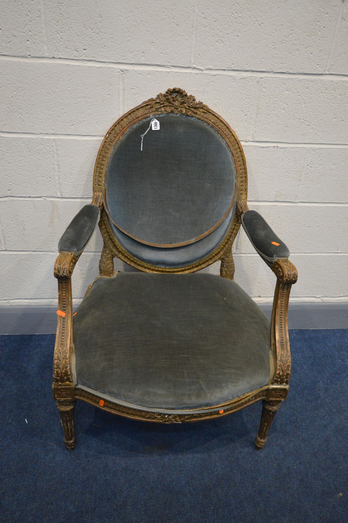 A LOUIS XVI STYLE, oval back with open armrests, on tapered fluted legs, width 67cm x depth 74cm x