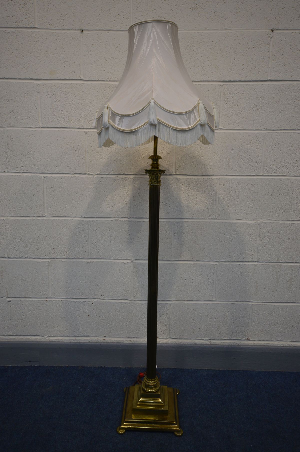 A BRASS CORINTHIUM COLUMN TELESCOPIC STANDARD LAMP, with a fabric shade