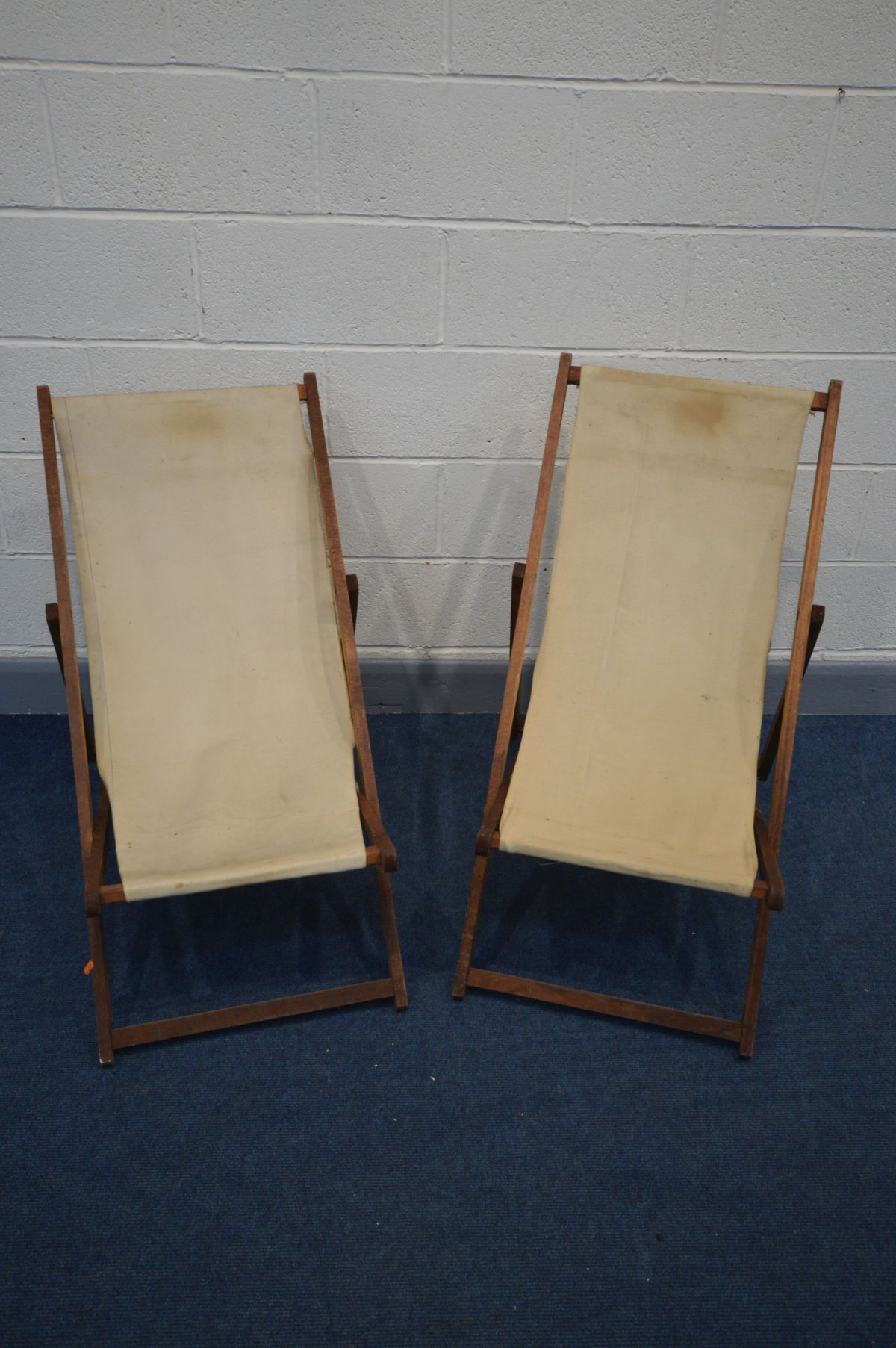 A PAIR OF VINTAGE DECK CHAIRS with cream upholstery