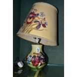 A MOORCROFT POTTERY SQUAT BALUSTER TABLE LAMP, in the Spring Flowers design, on pale yellow