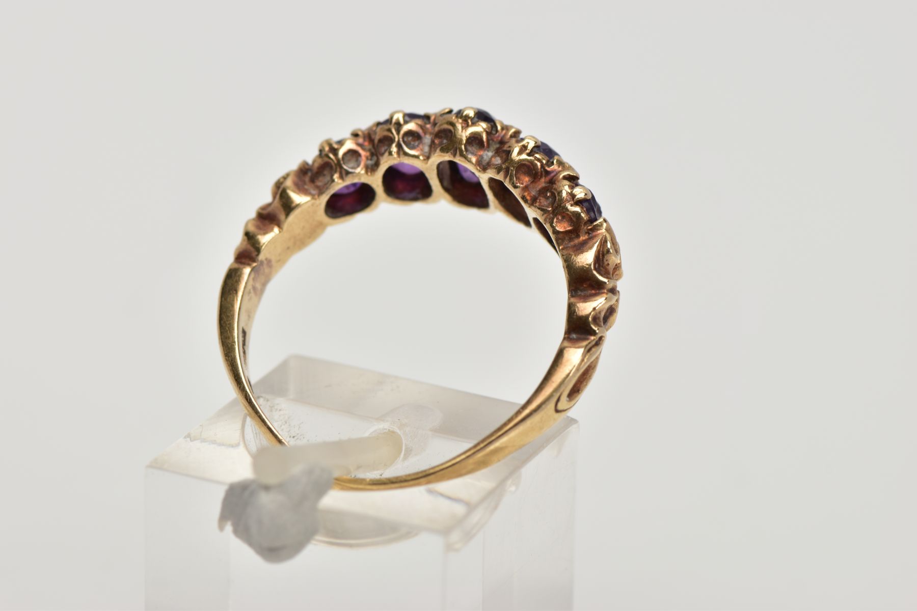 A 9CT GOLD FIVE STONE AMETYHST RING, designed with a row of five graduated oval cut amethyst, scroll - Image 3 of 4