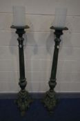 A PAIR OF ORNATE/GOTHIC CAST IRON PRICKET CANDLE STANDS, with later frosted cylindrical glass