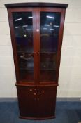 A SKOVBY ROSEWOOD EFFECT DISPLAY CABINET, with double glazed cupboard doors, above two drawers and