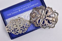 TWO SILVER NURSE BELT BUCKLES, the larger openwork floral and foliate design buckle, with the