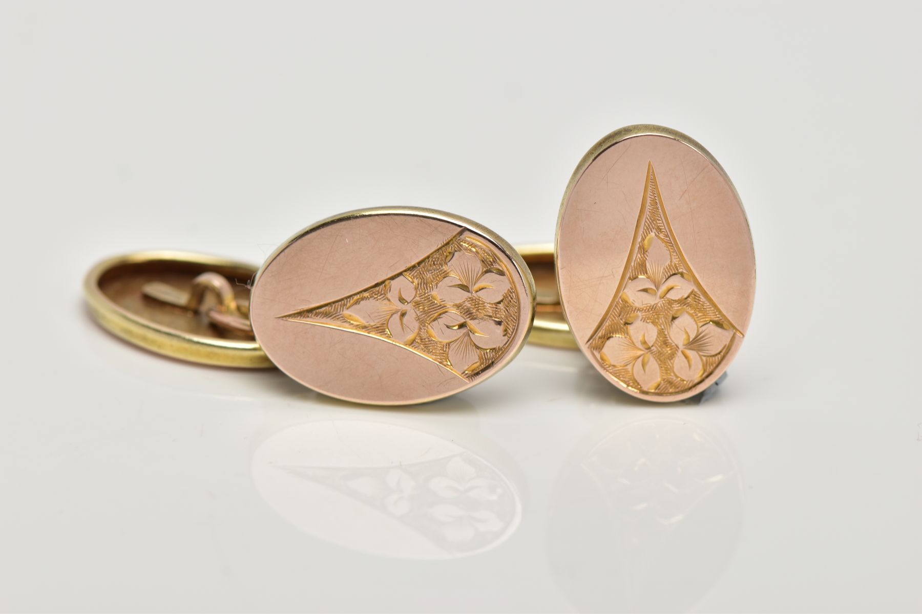 A PAIR OF 9CT GOLD CUFFLINKS, each of an oval form, engraved foliate design, hallmarked 9ct gold