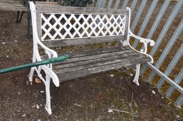 A CAST IRON GARDEN BENCH with wooden slatted seat and metal lattice back 170cm wide