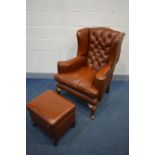 A BROWN LEATHER BUTTONED WING BACK ARMCHAIR, with flat outswept armrests, on cabriole front legs,