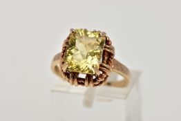 A 9CT GOLD DRESS RING, designed with a claw set rectangular cut stone assessed as citrine, rope