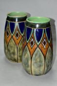 A PAIR OF EARLY 20TH CENTURY ROYAL DOULTON STONEWARE BALUSTER VASES, incised and glazed with
