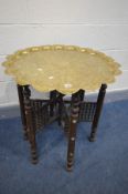 AN ANGLO-INDIAN BRASS TOP TABLE, depicting the Taj Mahal, on a folding Moorish style base,