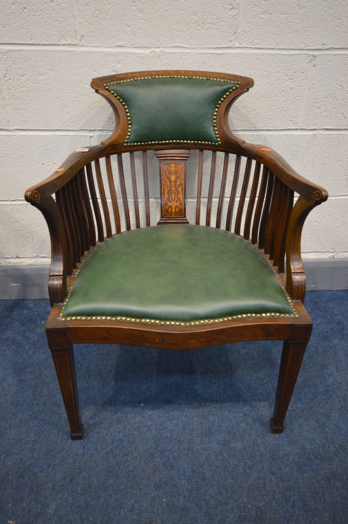 AN EDWARDIAN MAHOGANY AND MARQUETRY INLAID SQUARE SPINDLED BACK ARMCHAIR with green leather seat and