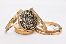 FOUR ROLLED GOLD HINGED BANGLES, each with an engraved foliate or scroll design, each with slide