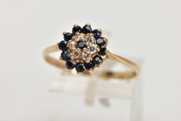 A 9CT GOLD SAPPHIRE AND CUBIC ZIRCONIA CLUSTER RING, raised cluster set with a central circular