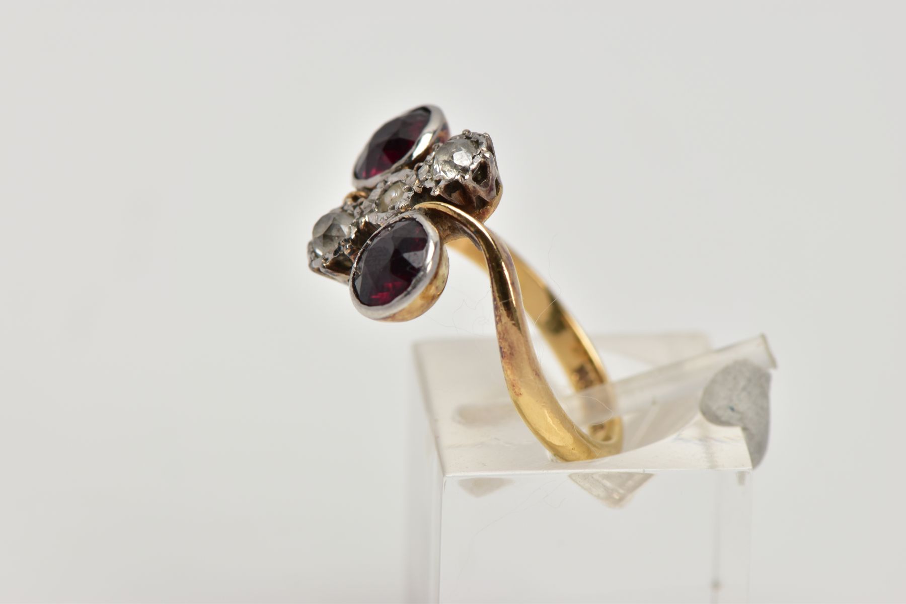 AN EARLY 20TH CENTURY 18CT GOLD GARNET AND DIAMOND DRESS RING, of a cross over design, the centre - Image 2 of 4