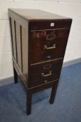 AN EARLY 20TH CENTURY MAHOGANY TWO DRAWER FILING CABINET, raised on square block legs, with a