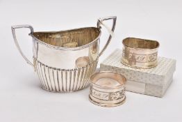 A SILVER SUGAR BOWL AND TWO NAPKINS, the sugar bowl of an oval form, stop reeding design to the
