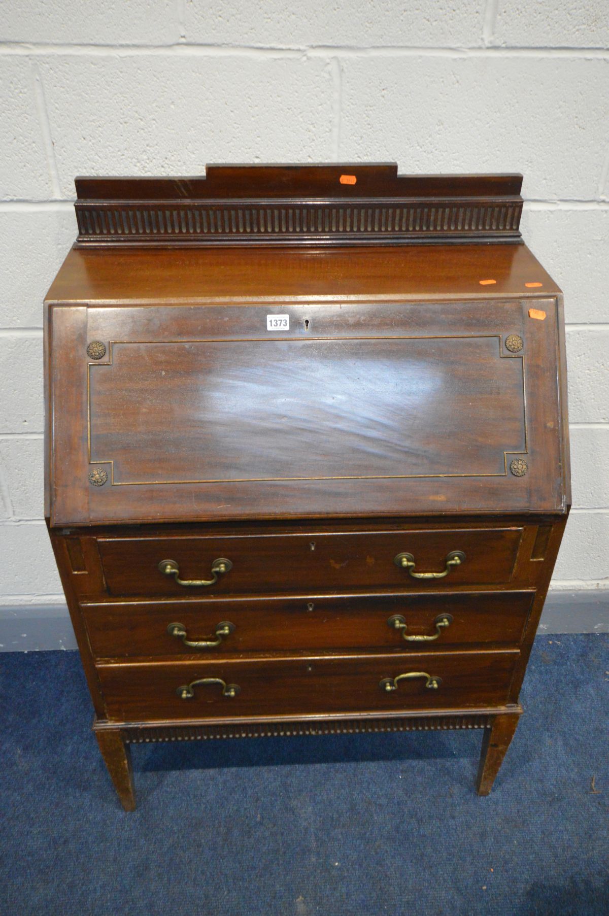 AN EDWARDIAN MAHOGANY FALL FRONT BUREAU, with a fitted interior, and three drawers, on square