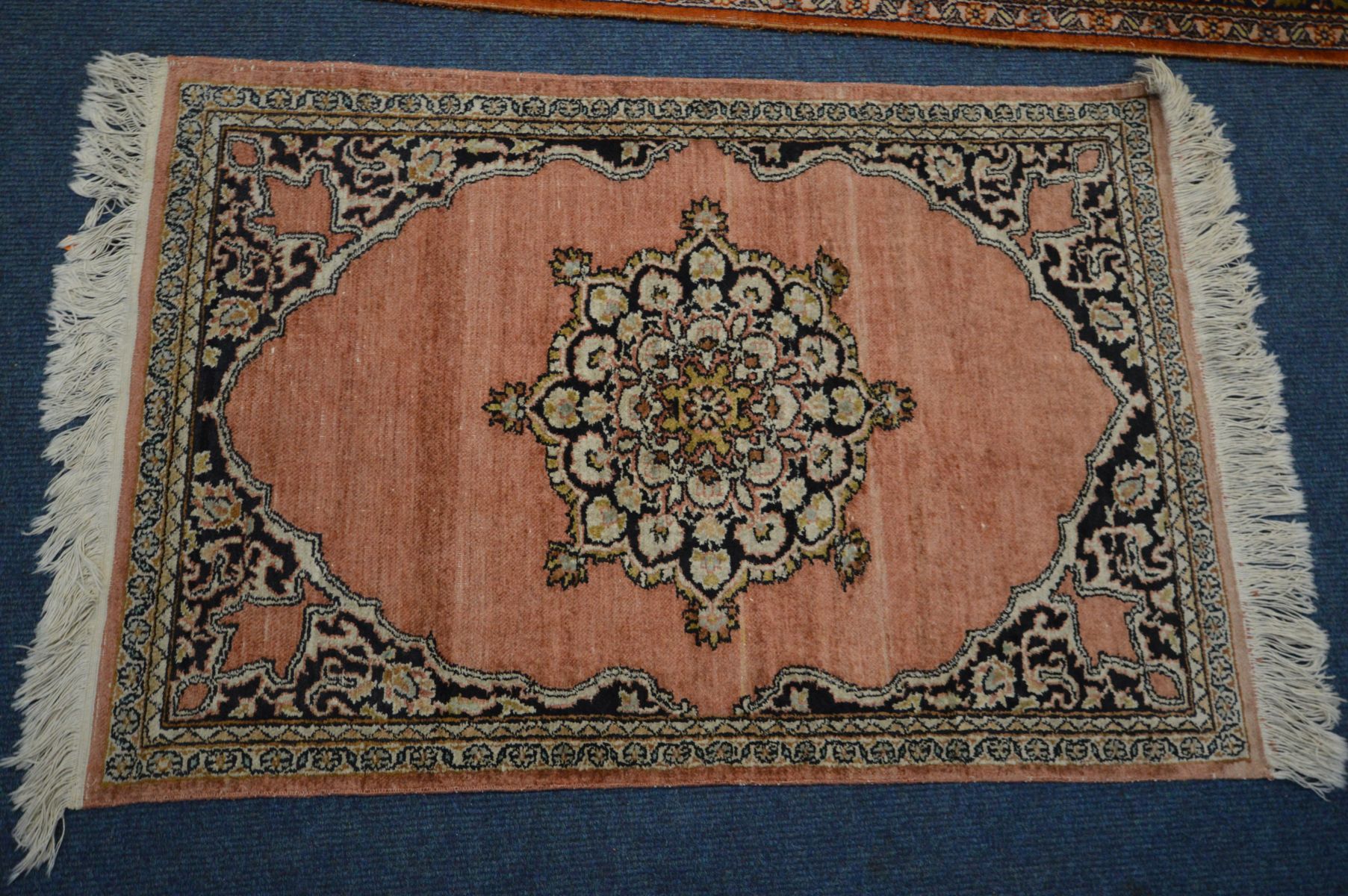 A KASHMIRI SILK RUG, scrolling foliate design on a red field, 182cm x 125cm, a woollen cream - Image 5 of 6