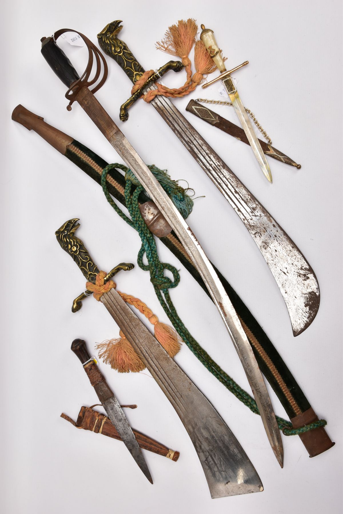 FIVE ASSORTED BLADED WEAPONS, two small short swords, curved blades, poorly constructed, knots in