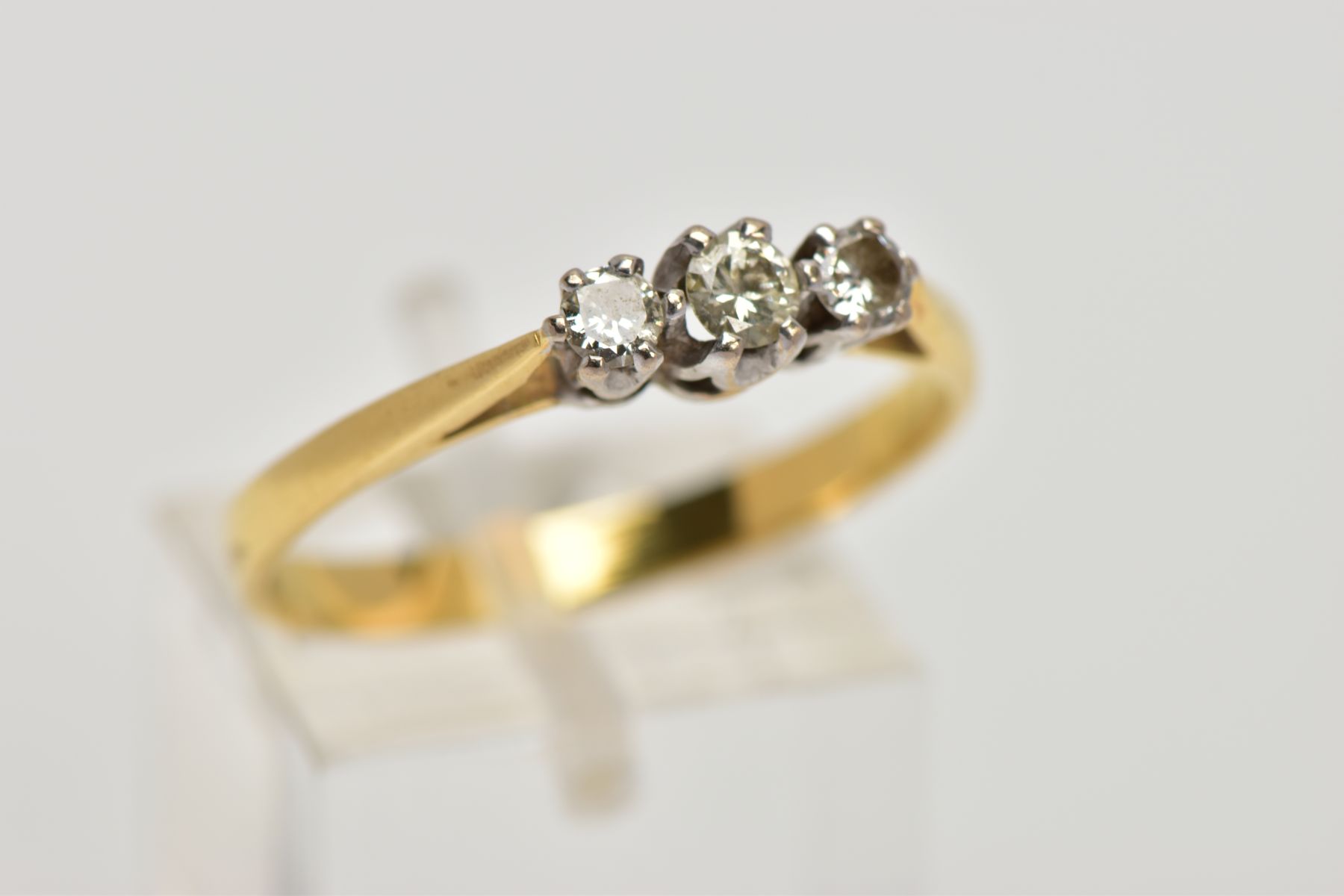 AN 18CT GOLD THREE STONE DIAMOND RING, designed with a row of three graduated round brilliant cut - Image 4 of 4