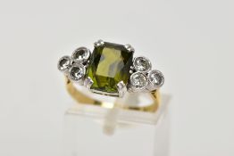 AN 18CT GOLD TOURMALINE AND DIAMOND DRESS RING, centring on an emerald cut green tourmaline, flanked