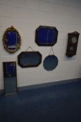 A MID 20TH CENTURY OAK WALL CLOCK (key and pendulum) along with two oak framed wall mirrors with