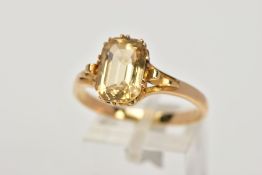 A YELLOW METAL YELLOW TOPAZ RING, designed with a claw set, rectangular cut yellow topaz, scroll